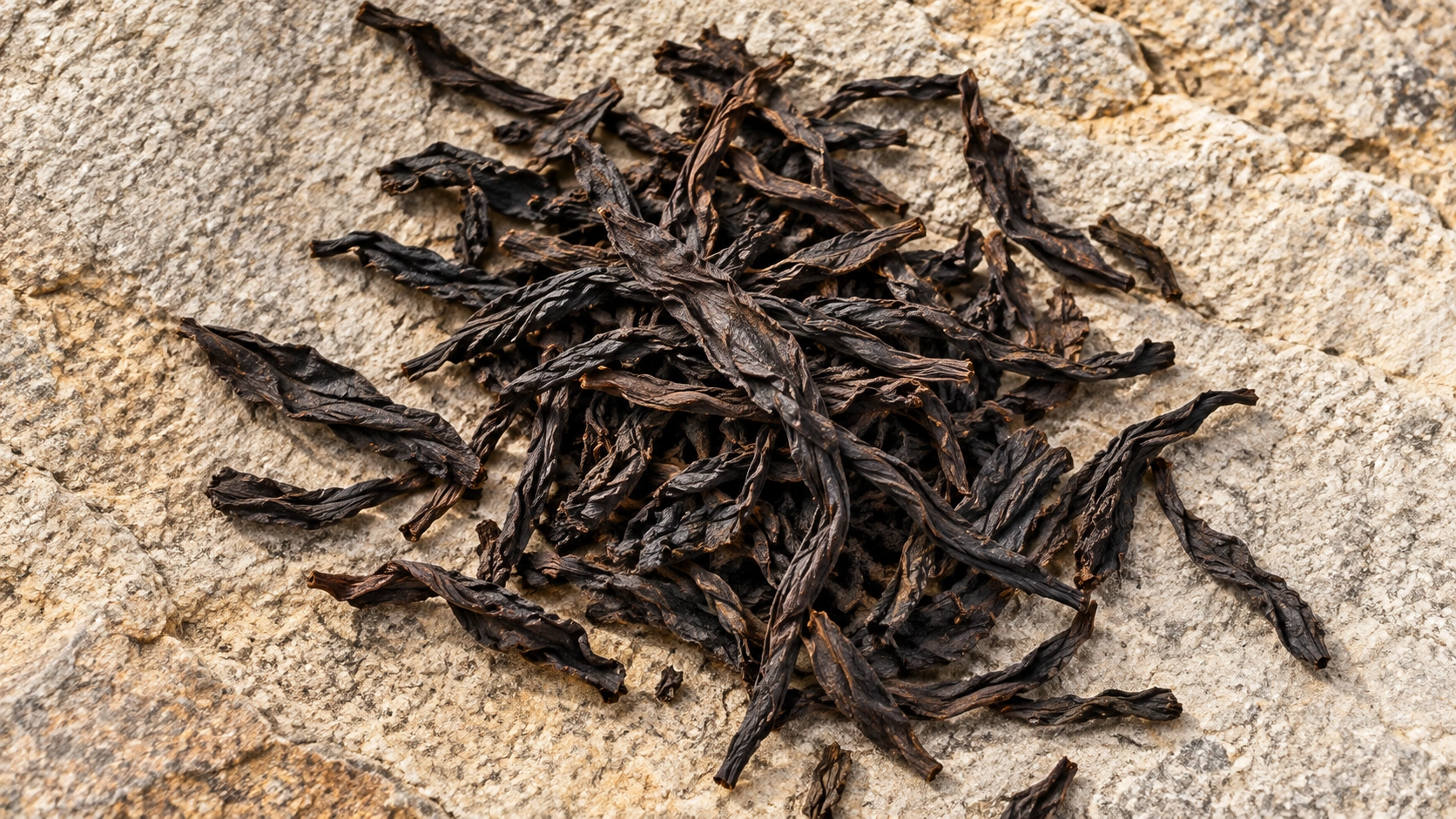 AI-generated editorial illustration: Dark twisted dry oolong-style tea leaves lying on textured stone; Da Hong Pao cultivar and origin unverified