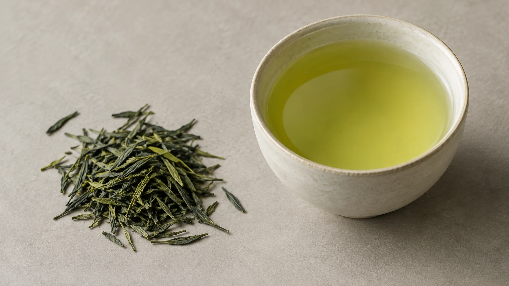 Green tea leaves and a pale infusion; decaffeination cannot be confirmed visually.