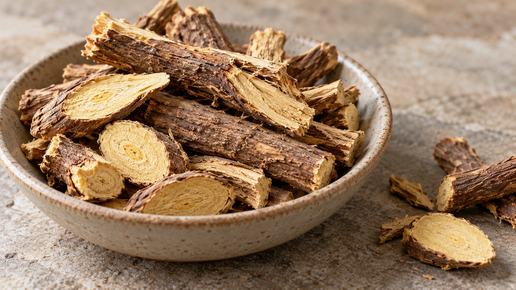 Original AI-generated editorial photograph of dried licorice root pieces and slices in a shallow ceramic bowl