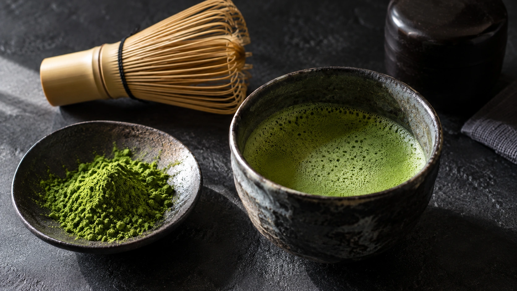 Original AI-generated editorial photograph of frothy green matcha in a chawan, with bamboo whisk and finely milled matcha powder